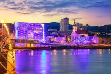 Foto op Plexiglas Linz, Austria. Cityscape image of riverside Linz, Austria during twilight blue hour with reflection of the city lights in Danube river. © rudi1976