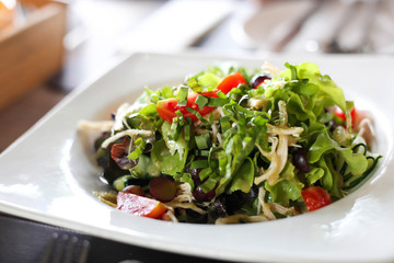 Delicious salad with chicken, nuts, egg and vegetables Fresh salad with chicken breast.