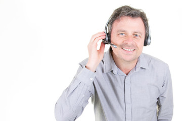 handsome young man in work in call-centre with headphones on white background with copy space