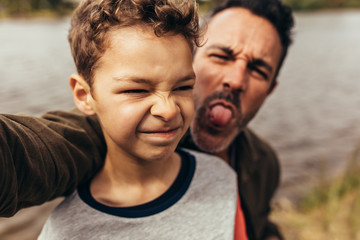 Portrait of father and son outdoors