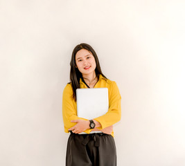 Obraz premium Smile Asian girl holding a laptop computer separately on a white background.