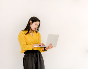 Smile Asian girl holding a laptop computer separately on a white background.