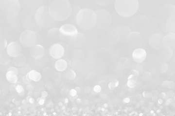 Silver white glittering Christmas lights. Blurred abstract background.