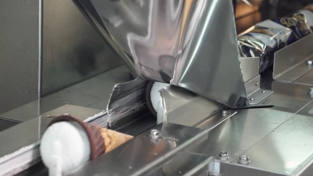 ice cream production, transportation waffle-cone with plombir ice cream on production line, packaging process, dairy products.