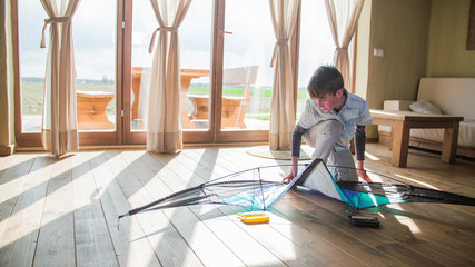 Boy put together kite at home