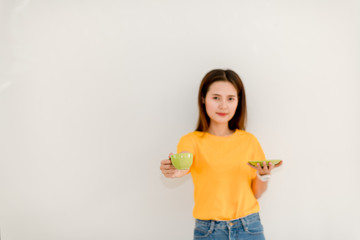 Asian girl is drinking coffee on a white background