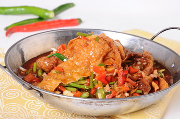 beef stew with carrots and tomatoes in bowl