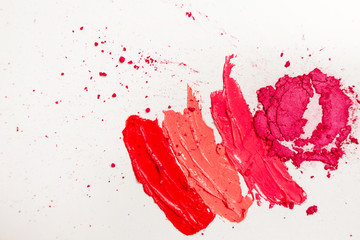 Lipstick and lip gloss, drops and strokes of different shades to create different images in makeup