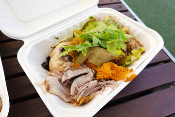 Traditional Maori food in a takeaway container.
