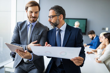 Successful team leader and business owner leading informal in-house business meeting