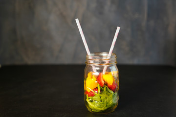 Components of healthy Green Reach Vitamins Smoothie with baby leaf spinach, mango, almond milk and strawberry