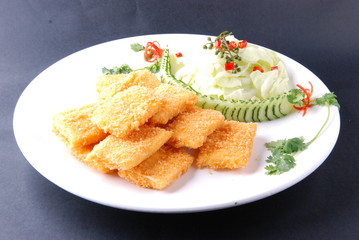 fried fish with lemon and parsley on plate
