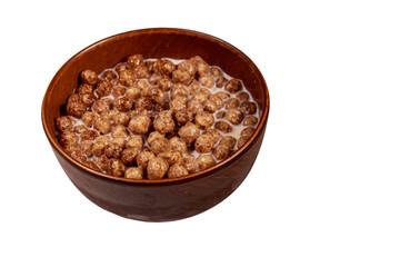 Cereal chocolate balls with milk in a bowl isolated on white background