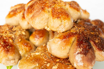 Freshly baked homemade buns with nut topping. Cocoa dough. Tasty, appetizing homemade cakes on a white background