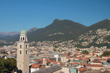 Bell tower, city and foothills of Alps. Lugano, Switzerland