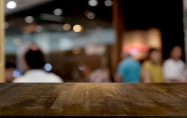 Empty dark wooden table in front of abstract blurred bokeh background of restaurant . can be used for display or montage your products.Mock up for space.