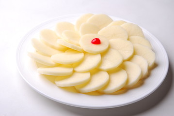 slices of fruit on plate isolated on white