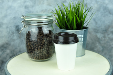 coffee bean and hot coffee in paper glass