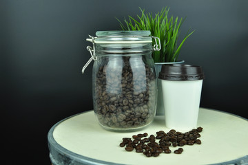 coffee bean and hot coffee in paper glass