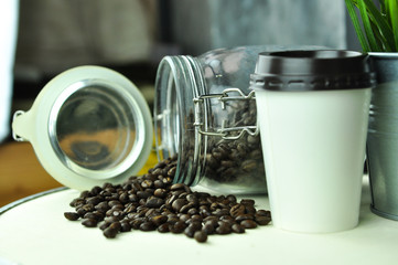 coffee bean and hot coffee in paper glass