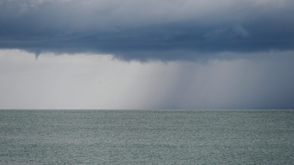 Seascape with rain in the distance