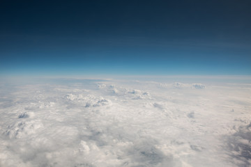 View from the airplane. Flight over the clouds