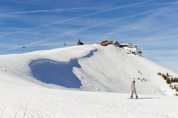 Fototapeta na wymiar Snowboarder on the ski slopes in the Alps 