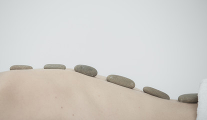 Fototapeta na wymiar Hot stone massage therapy at beauty center