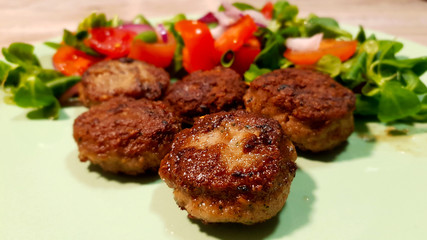 Hamburger made of minced veal with tomatoes and salad