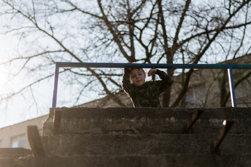 A little boy in a ruined territory.