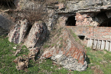 ruins of a blown up fortress with a sign with a destroyed walls