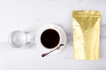 Top view of zip lock bag for coffee, cup of black hot coffee and glass of water.Template for coffee packaging