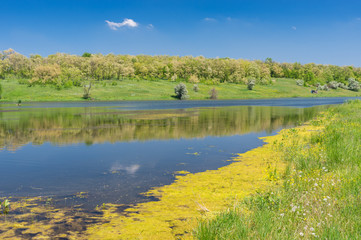 Sunny spring landscape with Suha Sura river in Vasylivka village near Dnepr city, central Ukraine