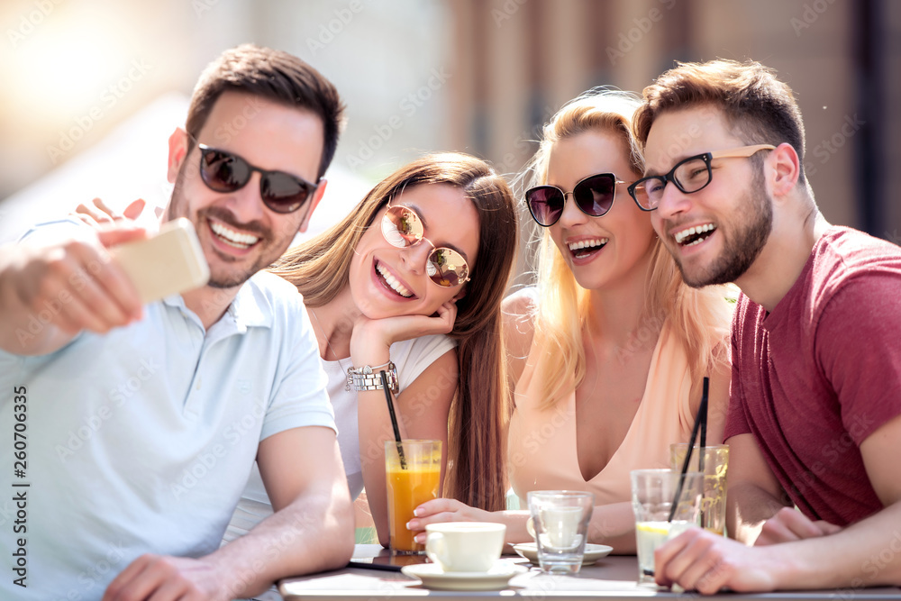 Canvas Prints group of four friends take selfie in cafe