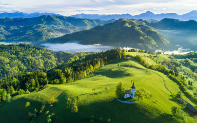 Aerial view of Slonevian hills with a church on the hilltop - obrazy, fototapety, plakaty