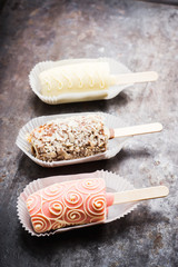 Bananas covered with chocolate on the rustic background. Selective focus. Shallow depth of field. 