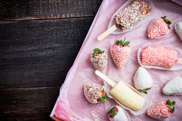 Strawberries and bananas covered with chocolate on the rustic background. Selective focus. Shallow depth of field.