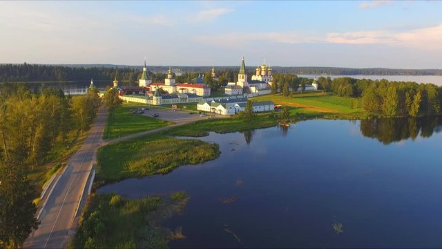 Top view from drone to Valdai Iversky Svyatoozersky Virgin Monastery for Men. Selvitsky Island, Valdai Lake. Bird's-eye view on summer evening