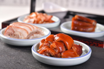 sausages on plate with tomatoes and glass of wine