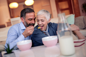 Mature couple have breakfast at home