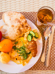 health breakfast background, fruits, croissant, omlette, juice, pita with hummus