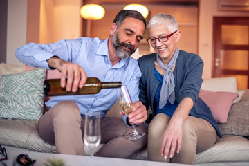 Senior couple at home drinking  wine