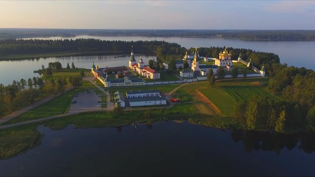 Top view from drone to Valdai Iversky Svyatoozersky Virgin Monastery for Men. Selvitsky Island, Valdai Lake. Bird's-eye view on summer evening