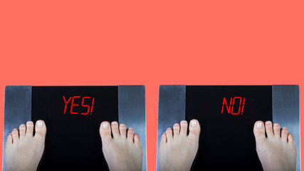 Two digital scales with female feet on them and red signs yes and no. Concept of weight control...