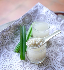 Barley water in glass and cooked pearly barley with pandan leaves