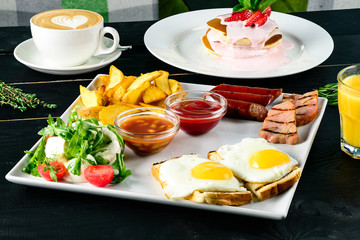 Continental breakfast on black table - bar menu. Coffee, orange juice.