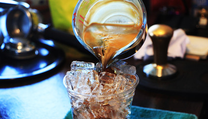 pouring coffee into glass.
