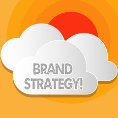 Fototapeta premium Writing note showing Brand Strategy. Business concept for long term plan development of successful brand achieve goals White Clouds Cut Out of Board Floating on Top of Each Other