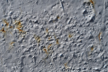 Old concrete wall with rusty stains and cracks. Rough wall texture