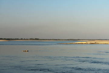 View on small fishing boat and Majuli Island  the world's biggest River Island, Assam India.